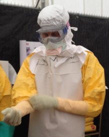 Adam C. Levine wears protective equipment, as he visits patients devastated by Ebola in Liberia. Photo courtesy of Huffington Post.