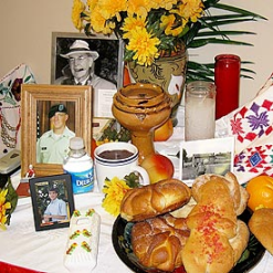 The centerpiece of the exhibit is a traditional ofrenda, an altar with food and beverage offerings, as well as flowers and photos of deceased family members. 