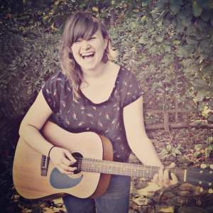 Sophomore Erin Wertz often sings and plays guitar at Open Mic Nights.  Photo credit Sarah Belinga 