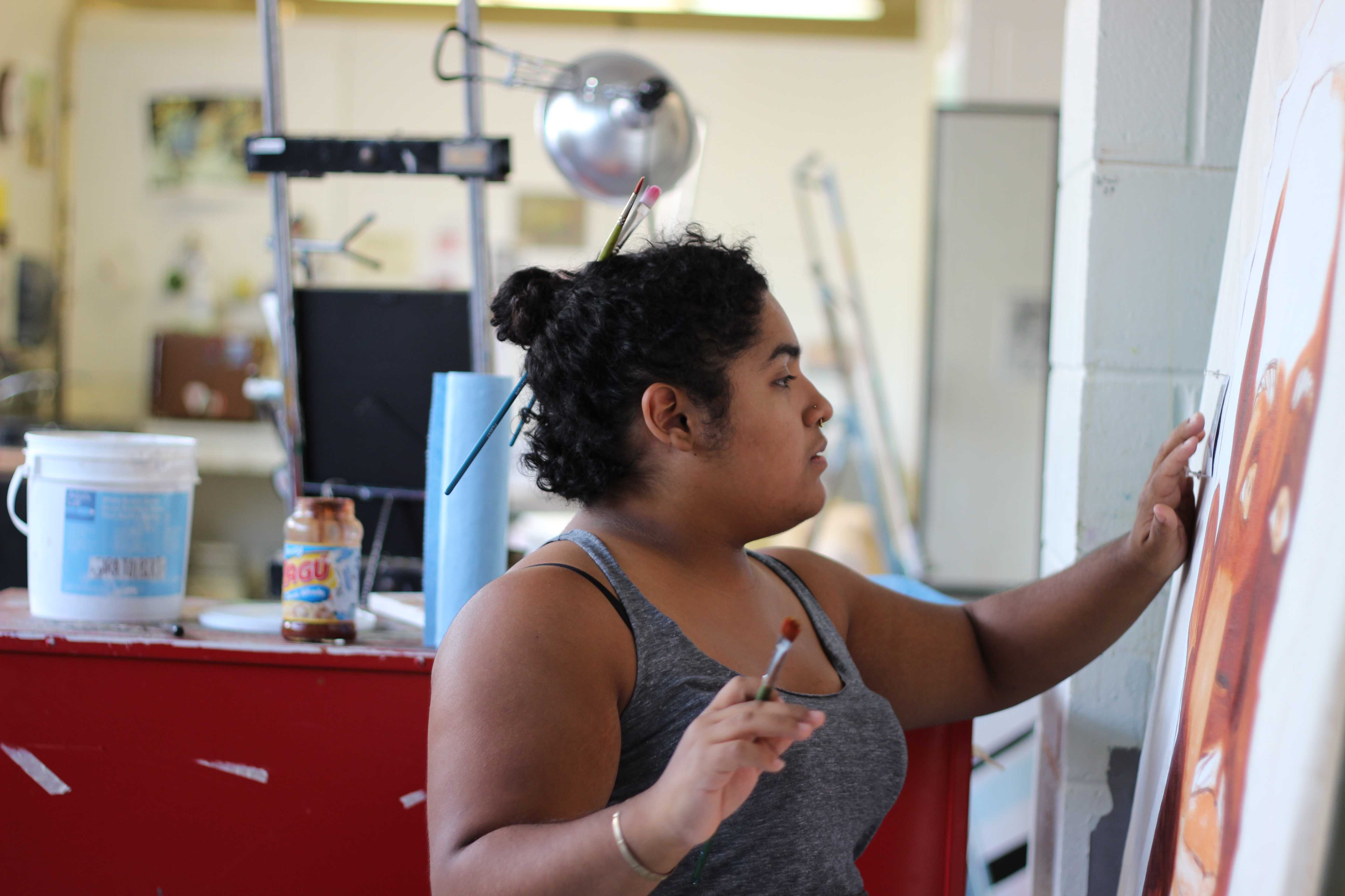 Tolbert works on her newest painting.