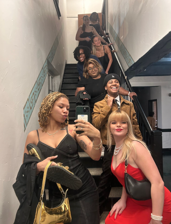 (From top to bottom) Ilea (Lea) Sheran, Cristina Battistini, Olivia Slayton, Triana Smallwood, Felicity Samuel, Caitlin Clements (CC), Chaise White, and Sydney Leggott pose for a group photo on the stairs leading to the venue. 
